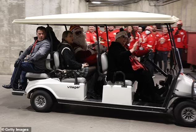 Taylor Swift is driven into Arrowhead Stadium on a golf cart with SANTA CLAUS... after jetting in from Nashville with her mom and dad to watch boyfriend Travis Kelce as Chiefs take on the Raiders