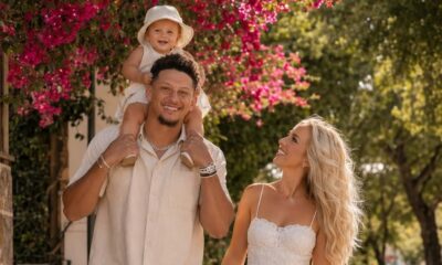 Patrick Mahomes and his gorgeous family enjoying a perfect sunny day together! Under a canopy of vibrant pink bougainvillea flowers, NFL superstar Patrick Mahomes walks hand-in-hand with his beautiful wife Brittany and their three precious children