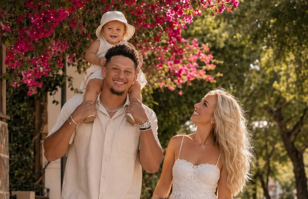 Patrick Mahomes and his gorgeous family enjoying a perfect sunny day together! Under a canopy of vibrant pink bougainvillea flowers, NFL superstar Patrick Mahomes walks hand-in-hand with his beautiful wife Brittany and their three precious children