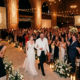 First Glimpse of the Moment Travis Kelce and Taylor Swift Stun in Pure White as They Walk Into MSG Hall for Their Wedding Rehearsal Dinner and Receive a Standing Ovation from Family, Friends, and A-List Celebrities... See Never-Before-Seen Photo