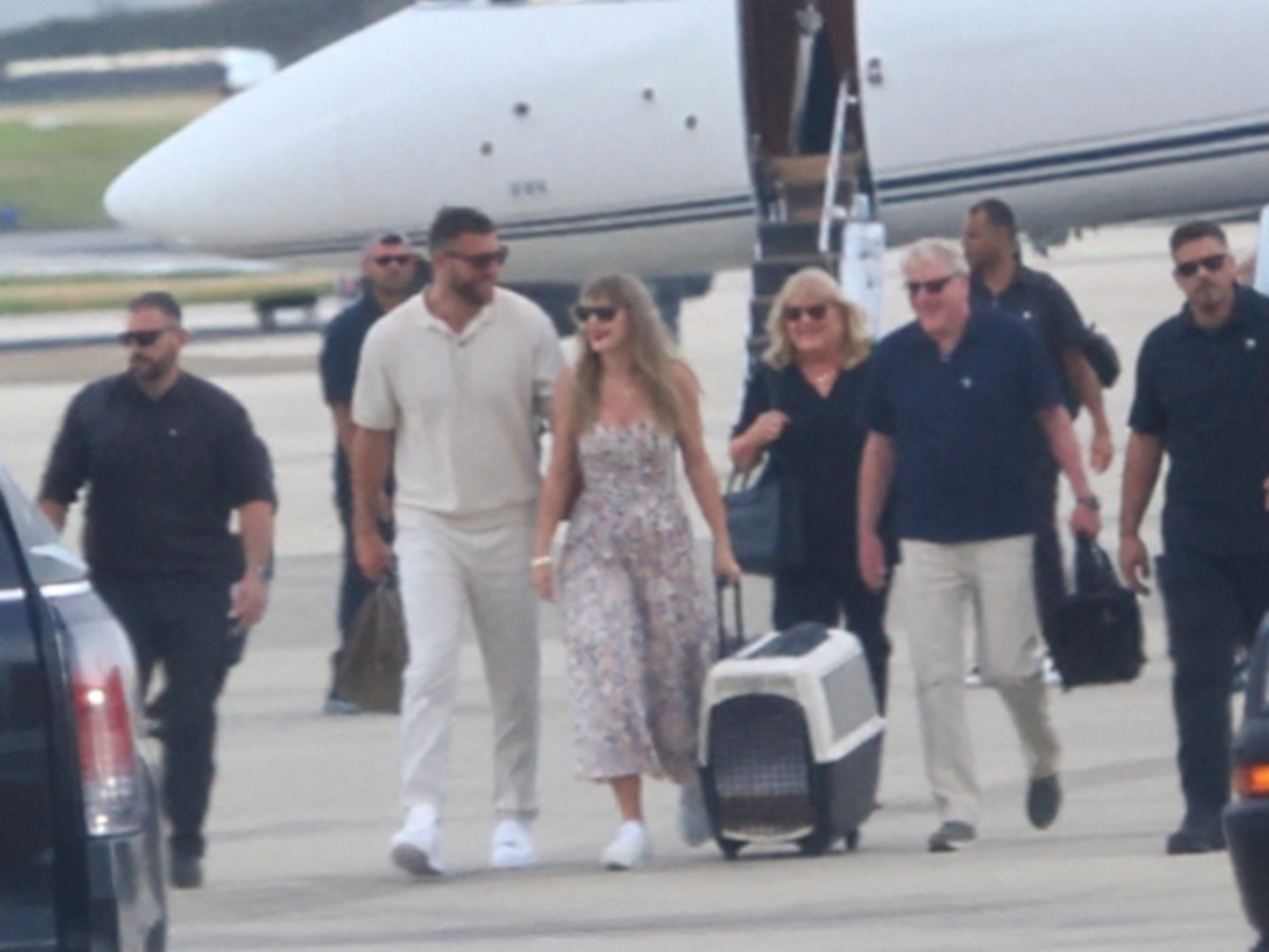 Travis Kelce and Wife Taylor Swift Arrive in Florida With Her Parents Andrea and Scott Swift on Taylor’s Private Jet in New Photos Ahead of the Chiefs vs. Dolphins Game, But a New Photo of Taylor Carrying a Custom Travel Carrier for Their New Samoyed, Wendy, Has Fans Asking the Same Question: Will She Break NFL and Stadium Protocol and Bring Their Pet to the Game?